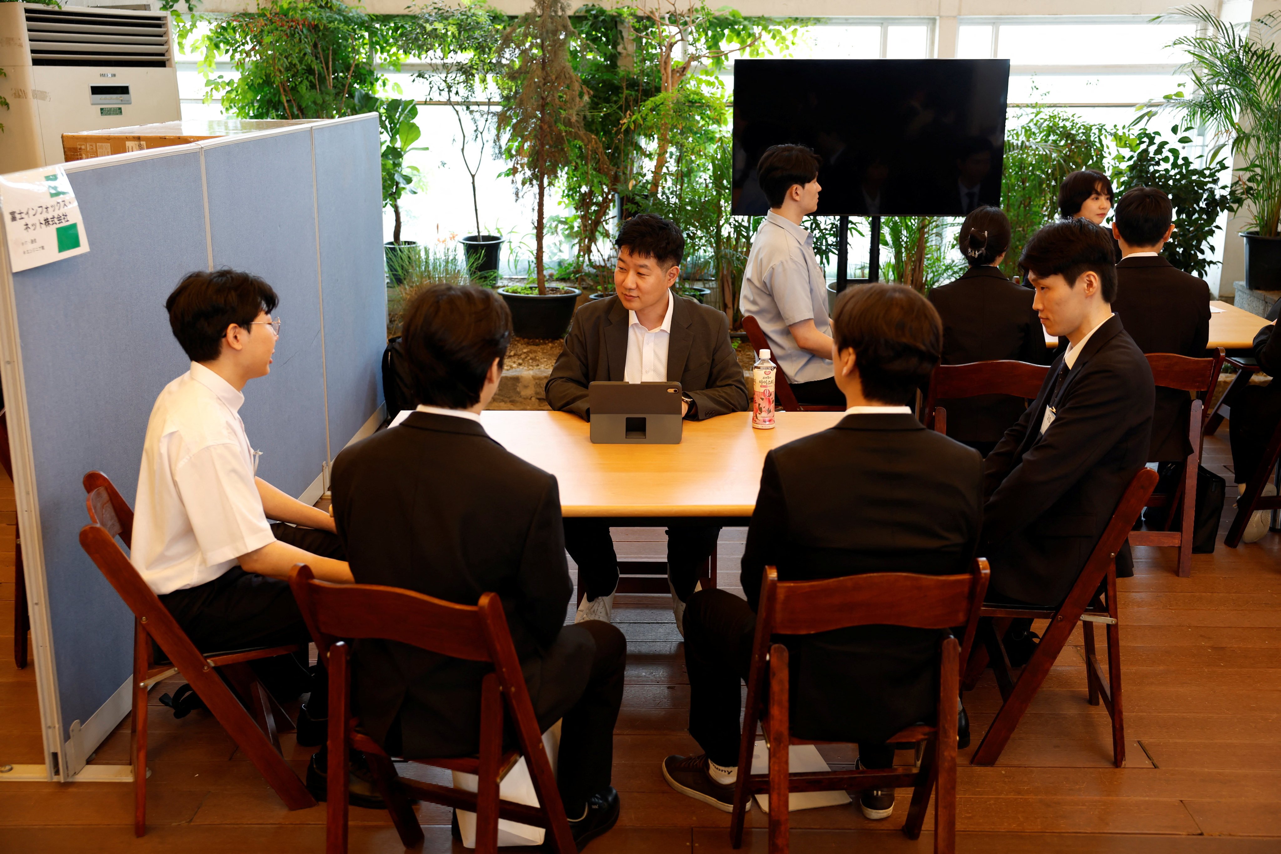 South Korean jobseekers take part in a group interview with representatives of a Japanese company during a job fair in Seoul on July 12. Photo: Reuters
