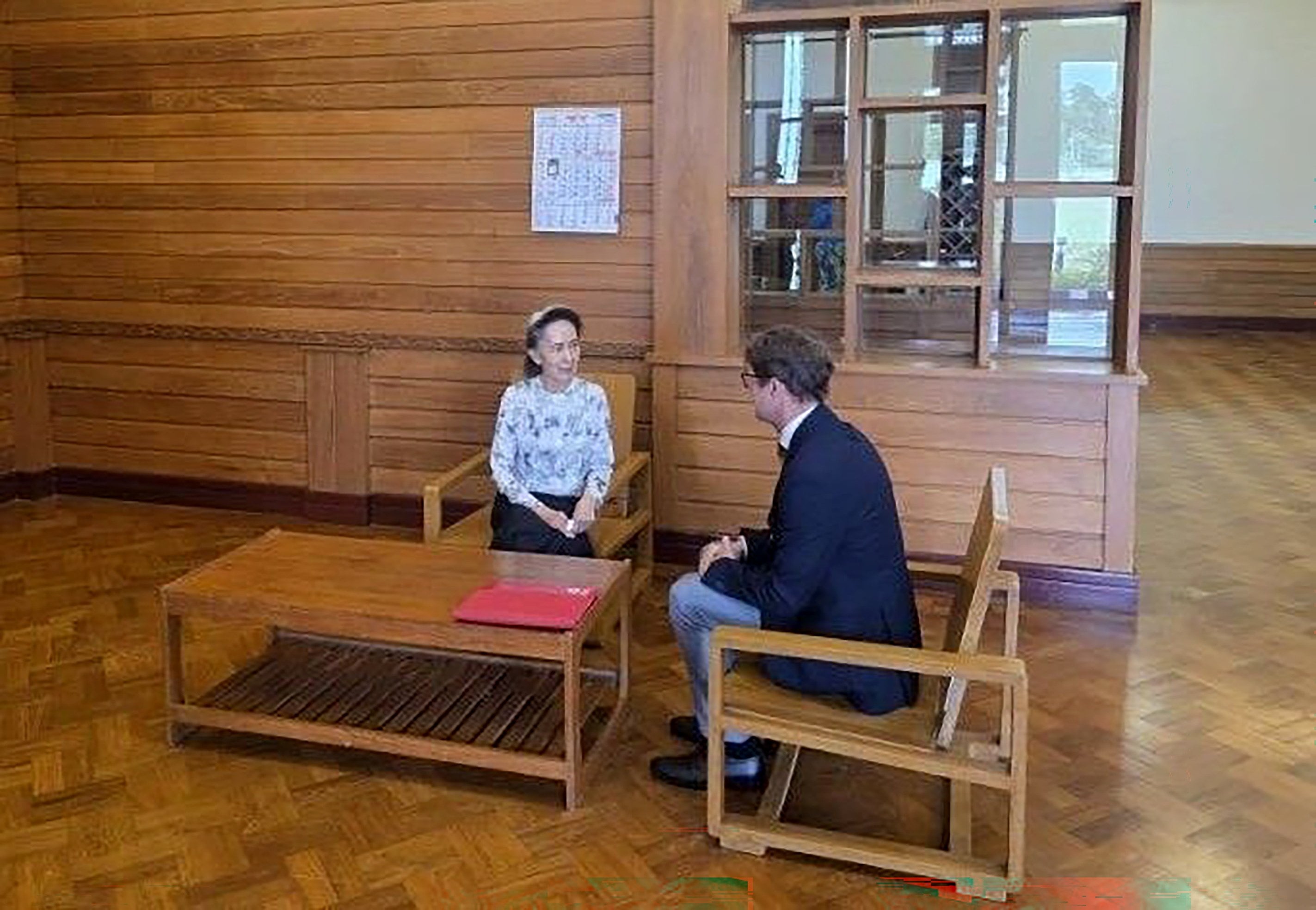 A Myanmar government handout photo shows ousted leader Aung San Suu Kyi (left) talking to Arnaud de Baecque in Naypyitaw on Monday. Photo: Myanmar President Office/EPA