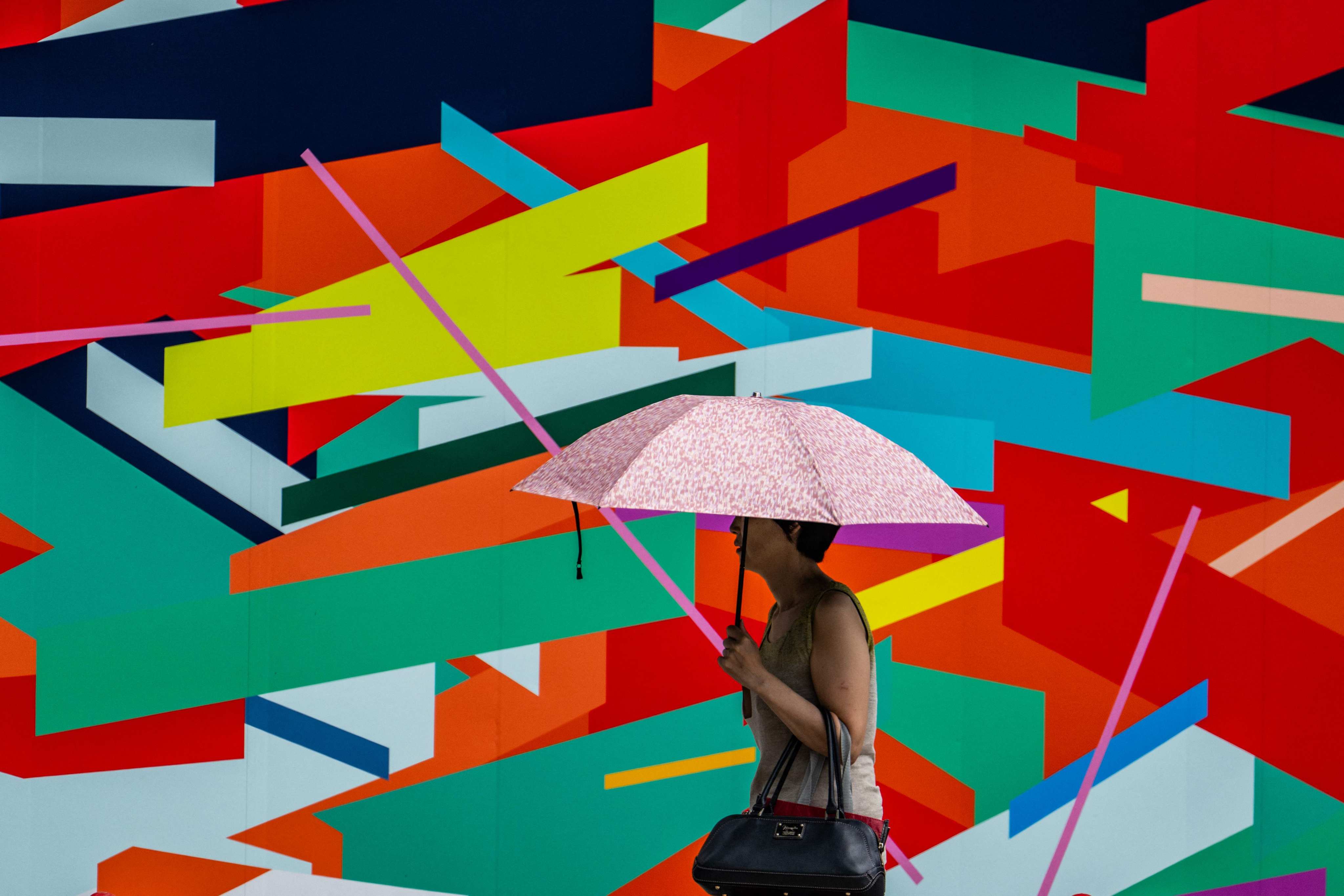 A woman uses an umbrella to shelter from the sun in Tokyo last month. Photo: AFP