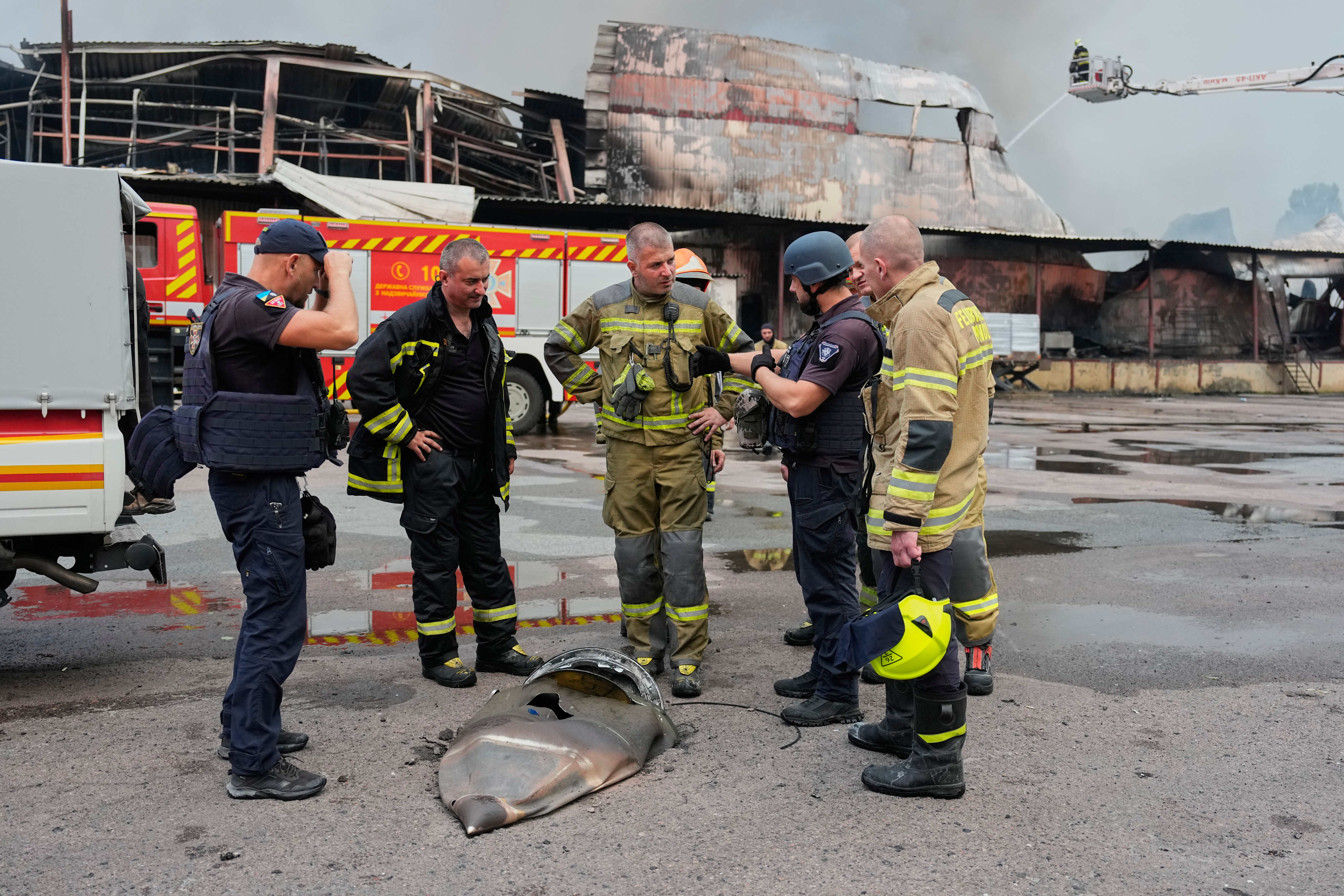Firefighters examine a fragment of a Russian missile near Kyiv. Photo: AP
