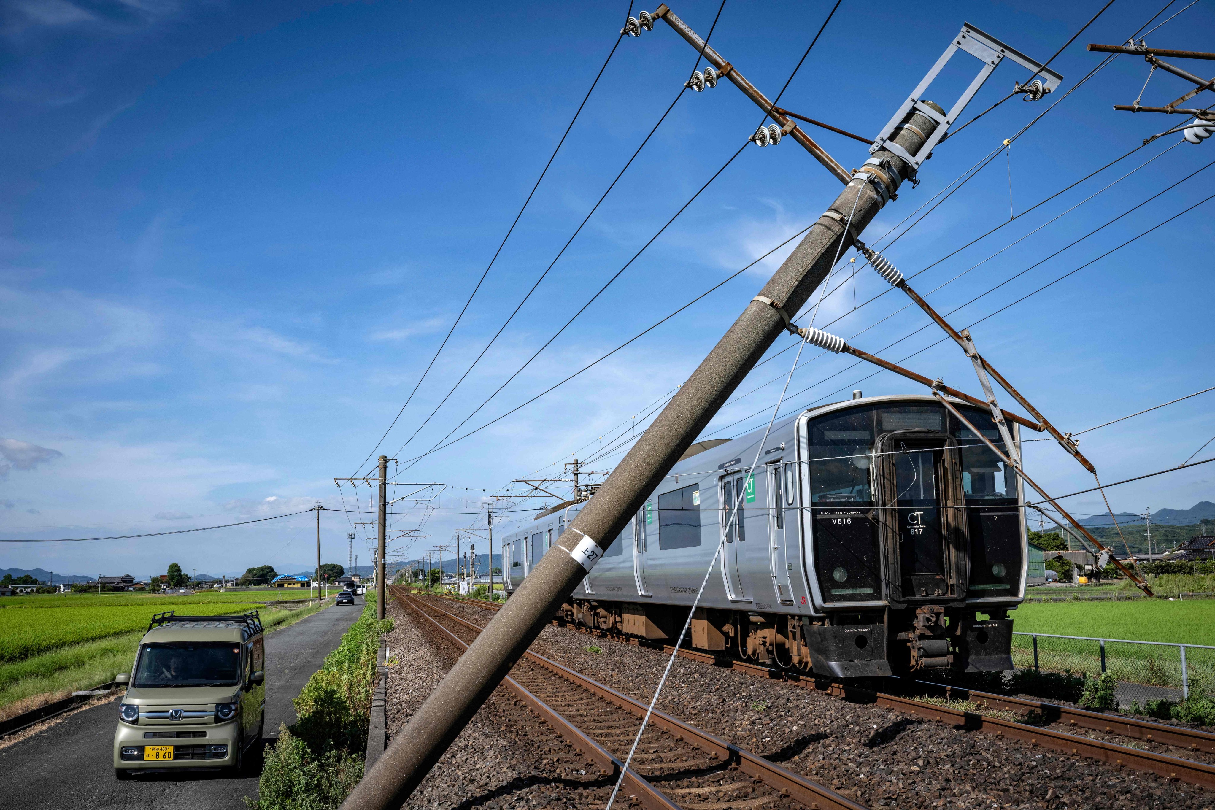 A train stands stopped after a utility pole fell onto the tracks following the July 28 earthquake in Yatsushiro, Kumamoto prefecture, on July 31. Photo: AFP