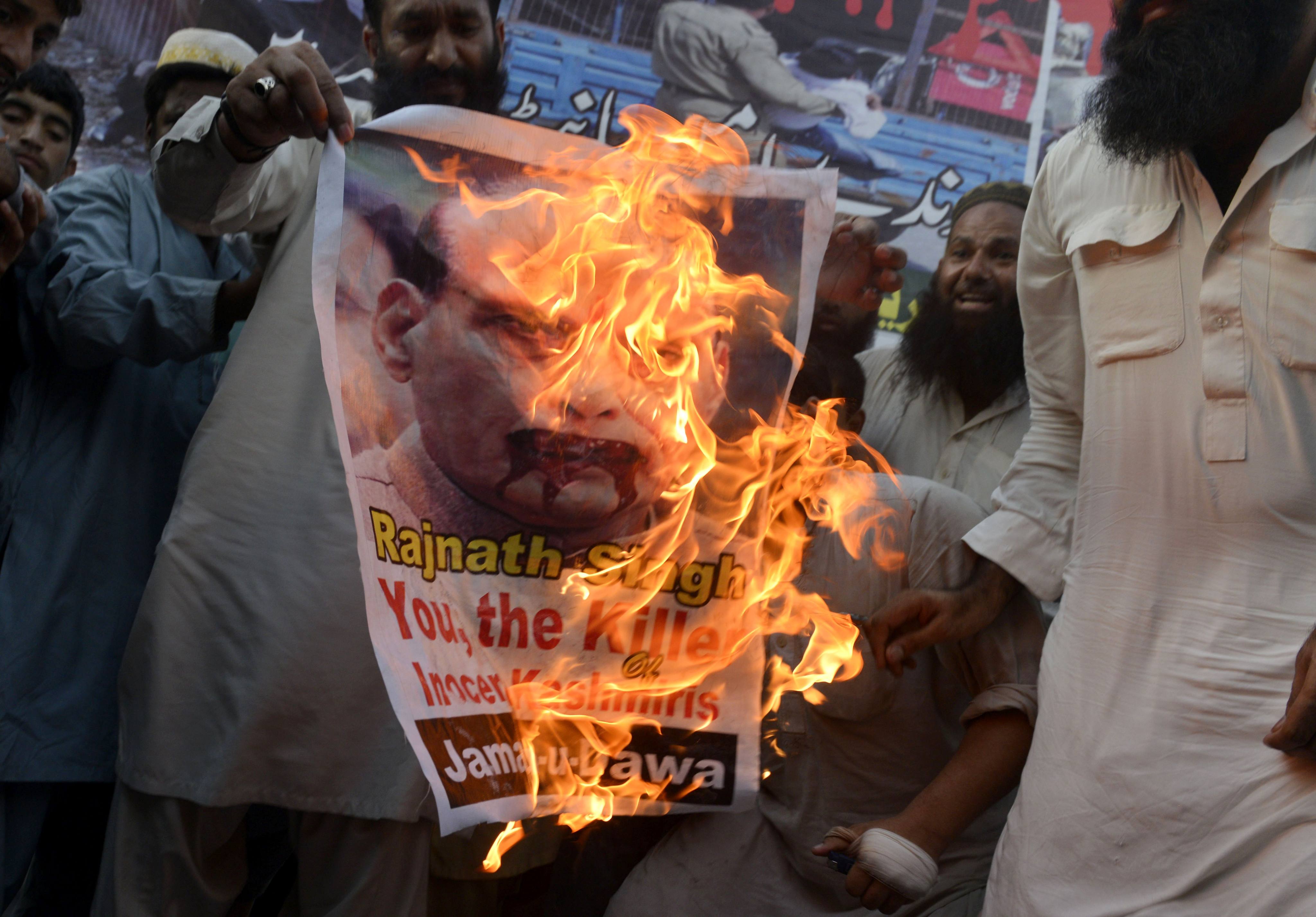 Pakistani hardline organisation Jamaat-ud-Dawa supporters burn a poster of then Indian home minister Rajnath Singh as he arrives in Lahore for a Saarc summit in Lahore on August 3, 2016. Photo: AFP