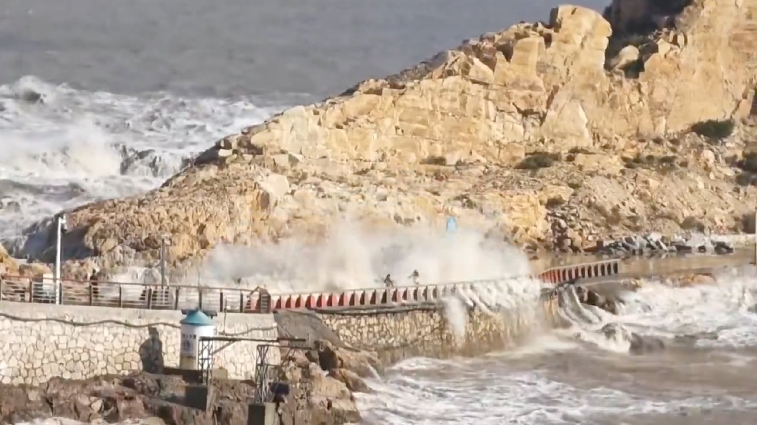 Video footage shows a family of two adults and two children — frantically sprinting across a stone and cement causeway that connects the mainland to a rocky offshore island. After a colossal wave several metres tall smashed over the path, a nine-year-old boy who has been missing since he was swept away by a giant wave in the eastern Chinese province of Zhejiang. Photo: Handout