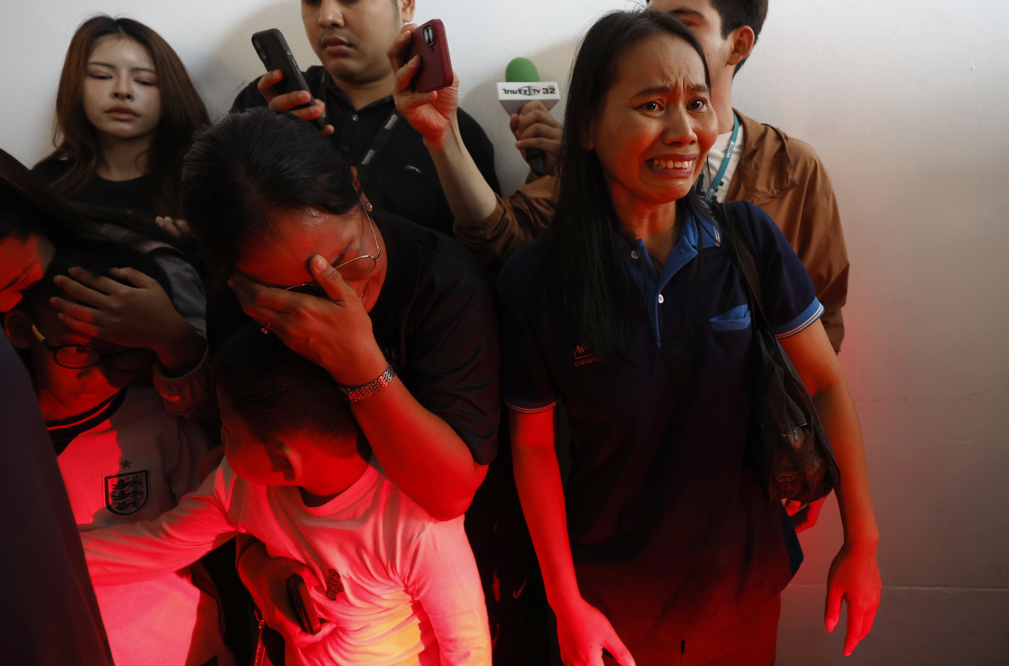 Relatives of a Thai teacher killed in the Debsirin Nonthaburi School shooting weep as they collect the body for funeral rites at a hospital in Bangkok on Saturday. Photo: EPA