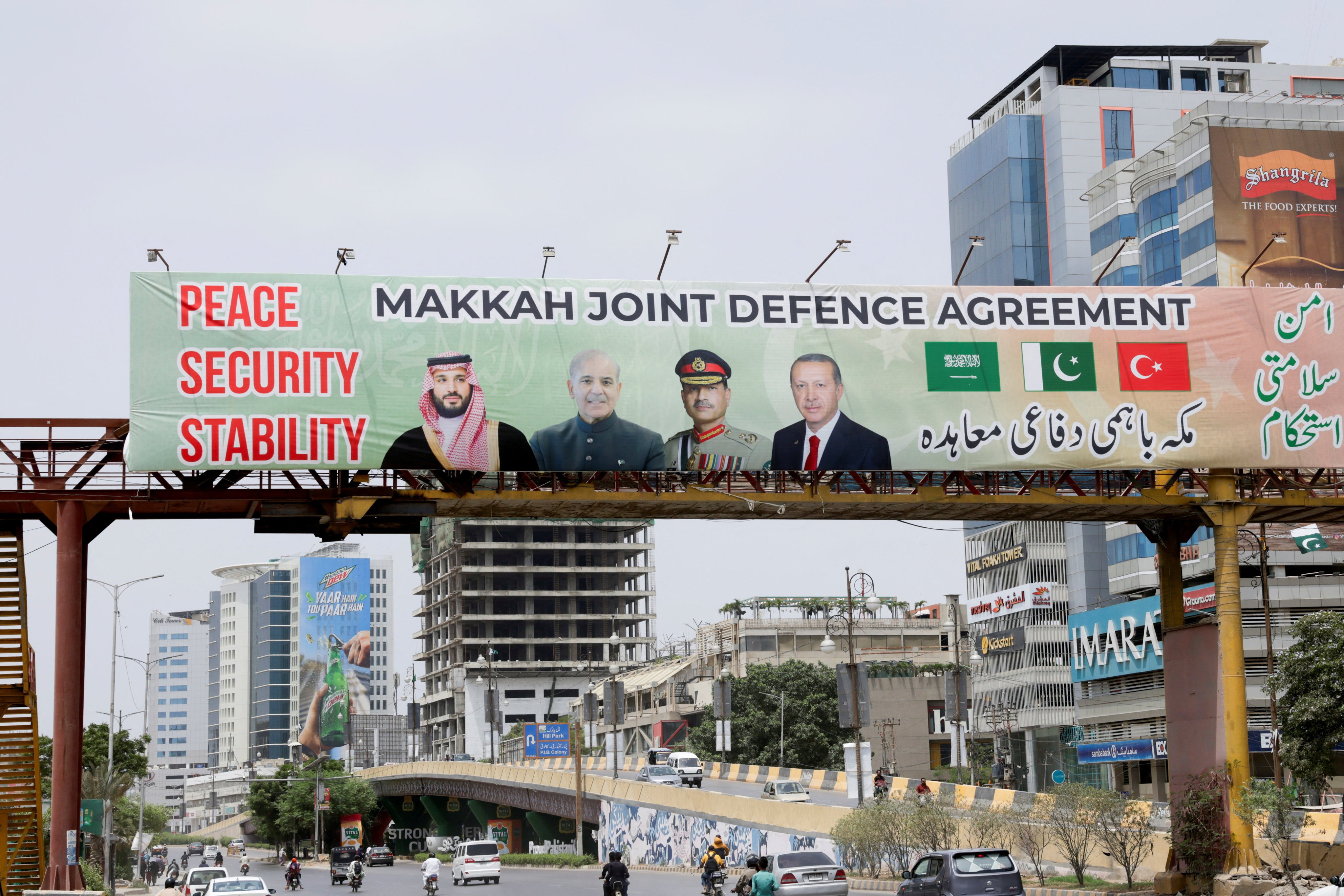 A billboard shows portraits of Saudi Crown Prince Mohammed bin Salman, Pakistan’s Prime Minister Muhammad Shehbaz Sharif, Pakistan’s military chief Asim Munir and Turkish President Recep Tayyip Erdogan, following the signing of the Mecca Joint Defence Agreement in Karachi on August 9. Photo: Reuters