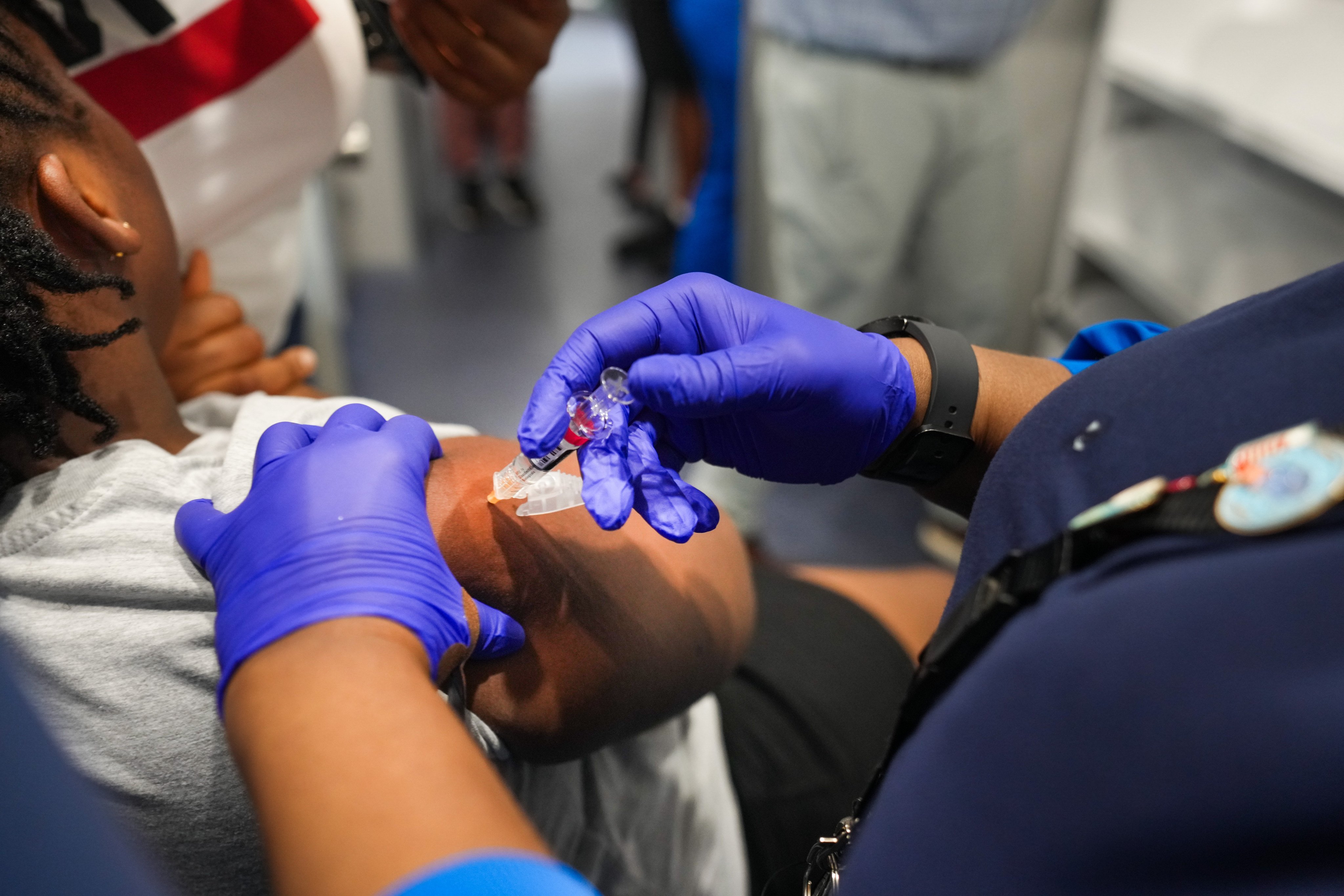 A nurse, vaccinates a girl inside a mobile clinic in Upper Darby, Pennsylvania. Photo: TNS