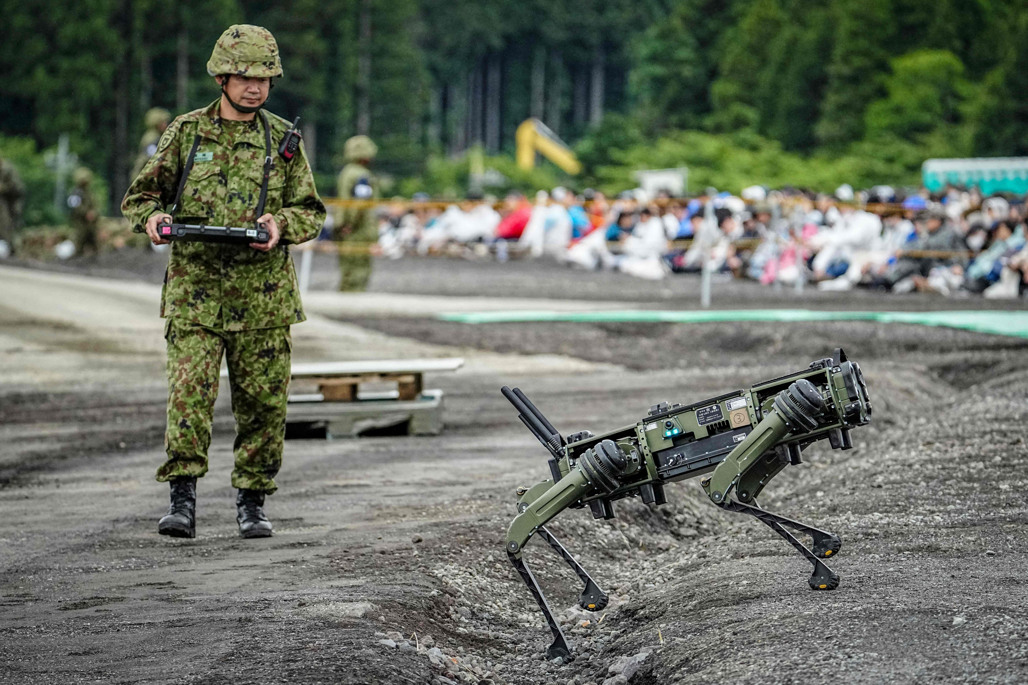 A Japan Ground Self-Defence Force soldier operates a quadrupedal unmanned ground vehicle during a live fire exercise in Gotemba on June 7. Photo: AFP