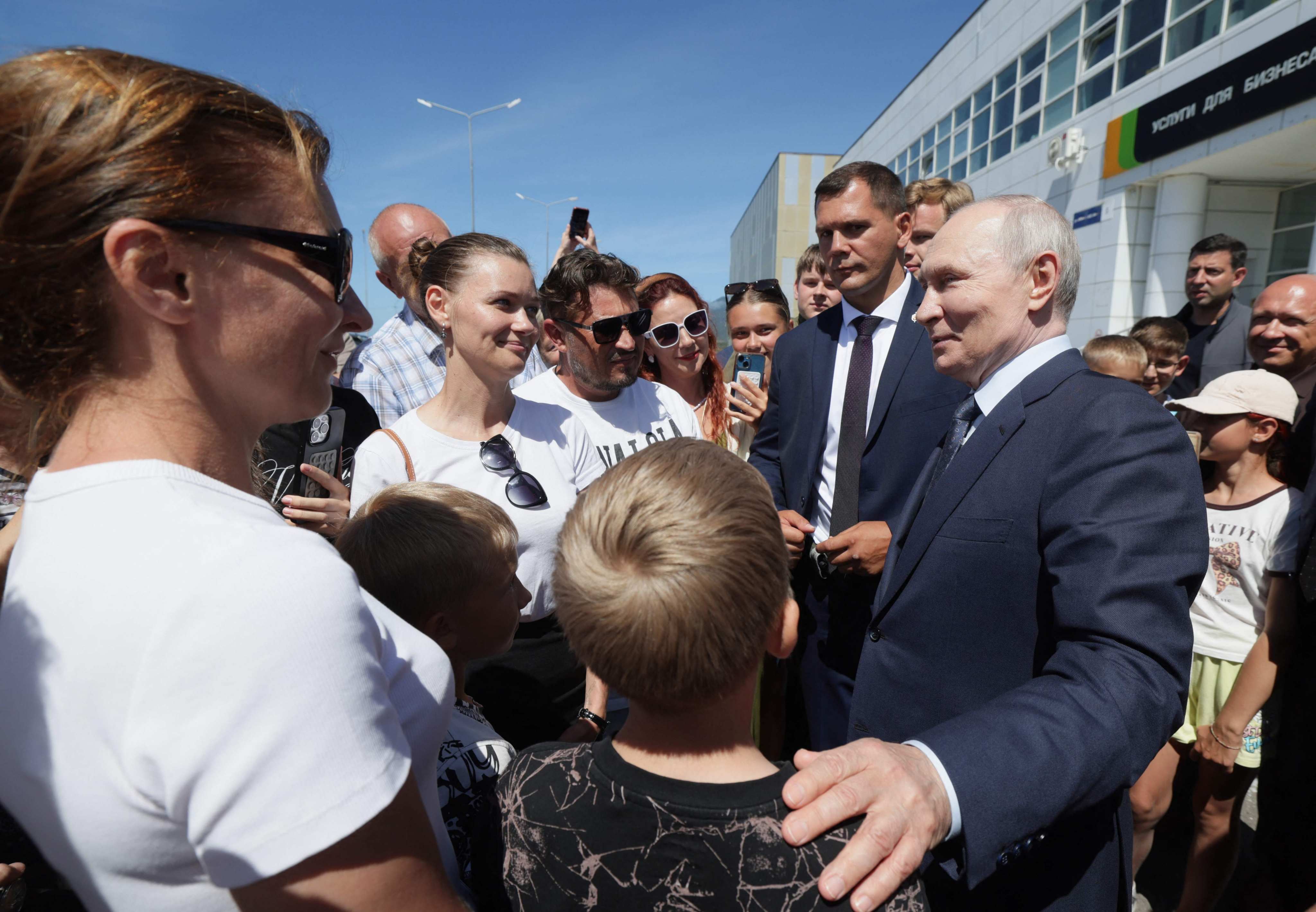 Vladimir Putin interacts with residents of Iturup Island during his visit on August 13. Photo: AFP