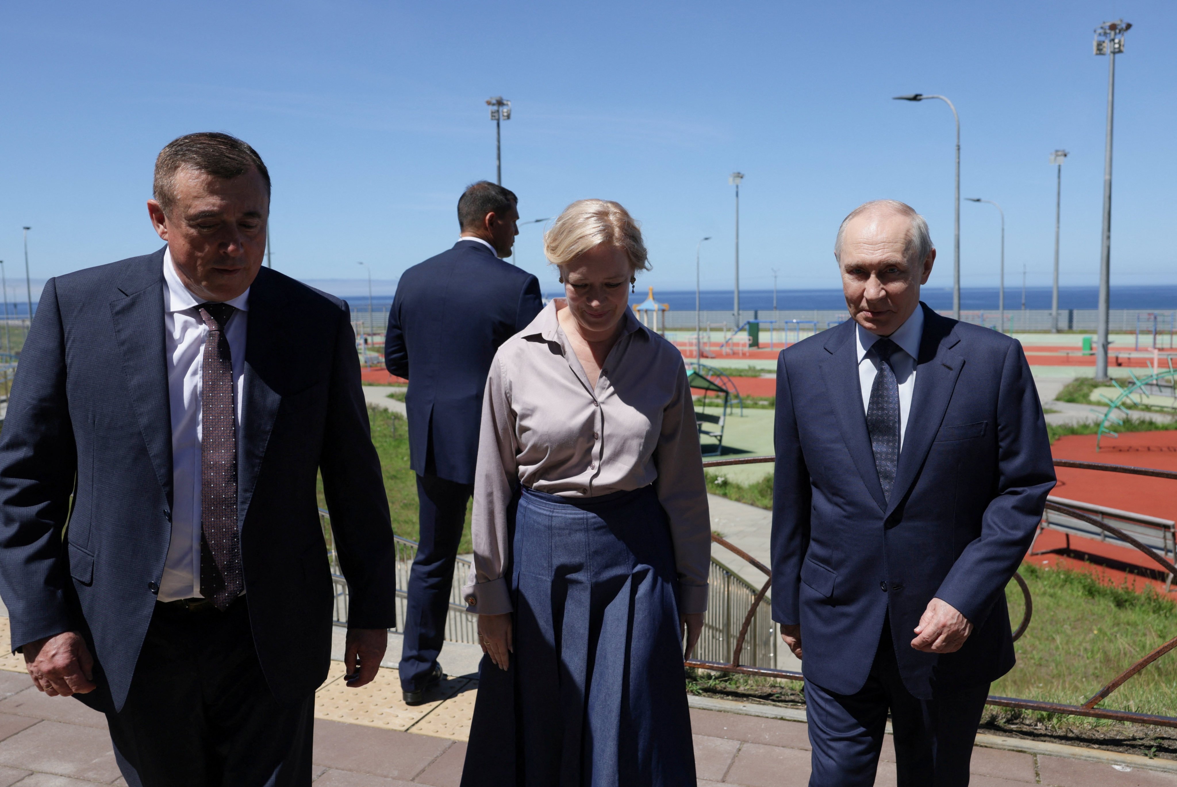 Russia’s Vladimir Putin tours Iturup on August 13, accompanied by Sakhalin region governor, Valery Limarenko, and regional Minister of Education Anastasia Kikteva. Photo: Sputnik/Reuters