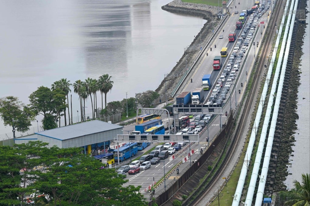 Vehicles coming from Johor Bahru in Malaysia queue near an immigration checkpoint to enter Singapore on March 31, 2023. Photo: AFP