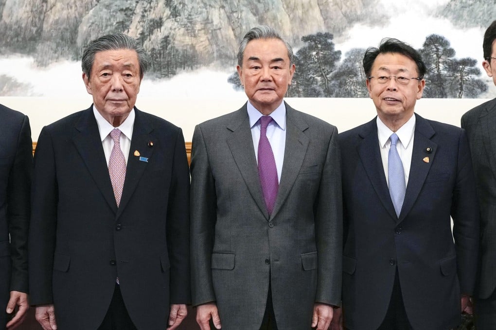 Hiroshi Moriyama (left), secretary general of Japan’s ruling Liberal Democratic Party, Chinese Foreign Minister Wang Yi, and Makoto Nishida, secretary general of Japan’s Komeito party, in Beijing on Tuesday. Photo: Kyodo