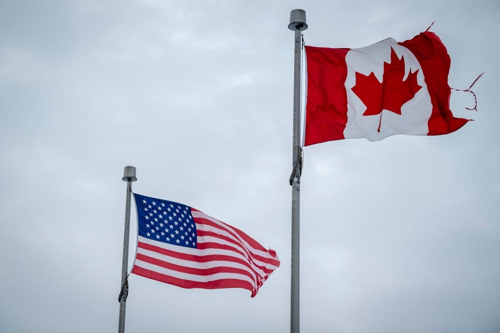The Canadian and US flags fly near the Canada-US border in Blackpool, Quebec. Photo: AFP