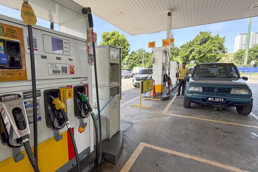 A motorist pumps fuel at a petrol station in Kuala Lumpur. Photo: AP
