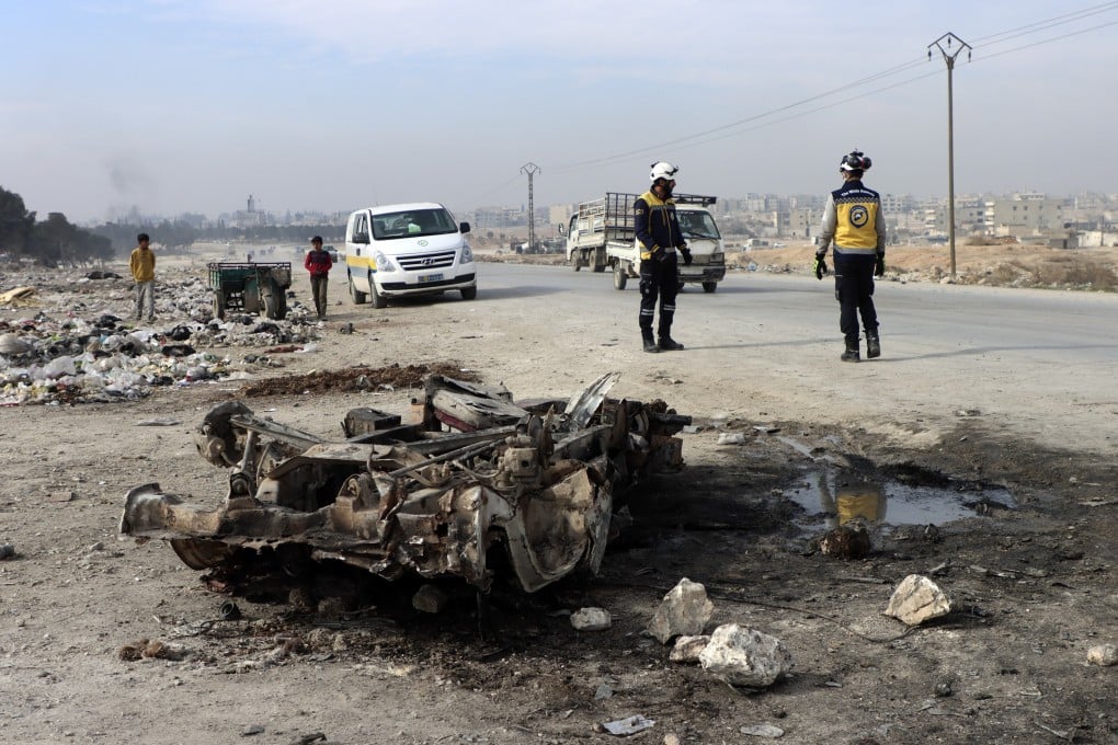 Syrian White Helmet civil defence workers inspect the site of a car bomb attack on the outskirts of Manbij, Syria on Monday. Photo: Syrian Civil Defence White Helmets via AP