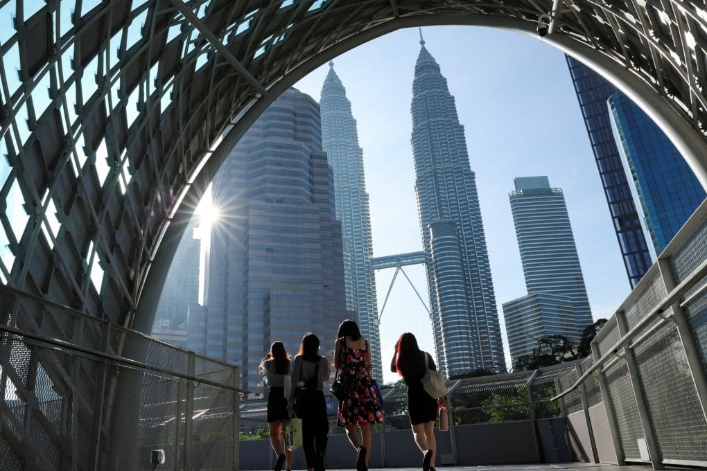 People walk through Kuala Lumpur. Malaysia cannot seem to shed its thin skin when it comes to issues of race and faith. Photo: Reuters