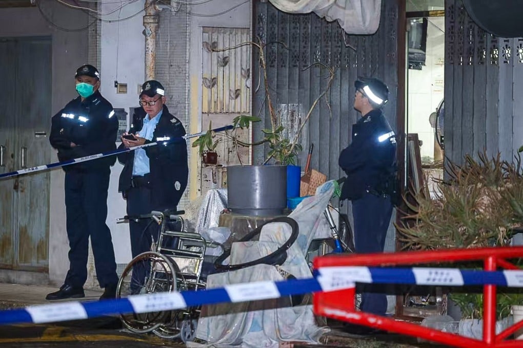 Police outside the two elderly victims’ ground-floor flat in Chun Hing San Tsuen, off Wang Tat Road, in Yuen Long, at about 8pm. Photo: Handout