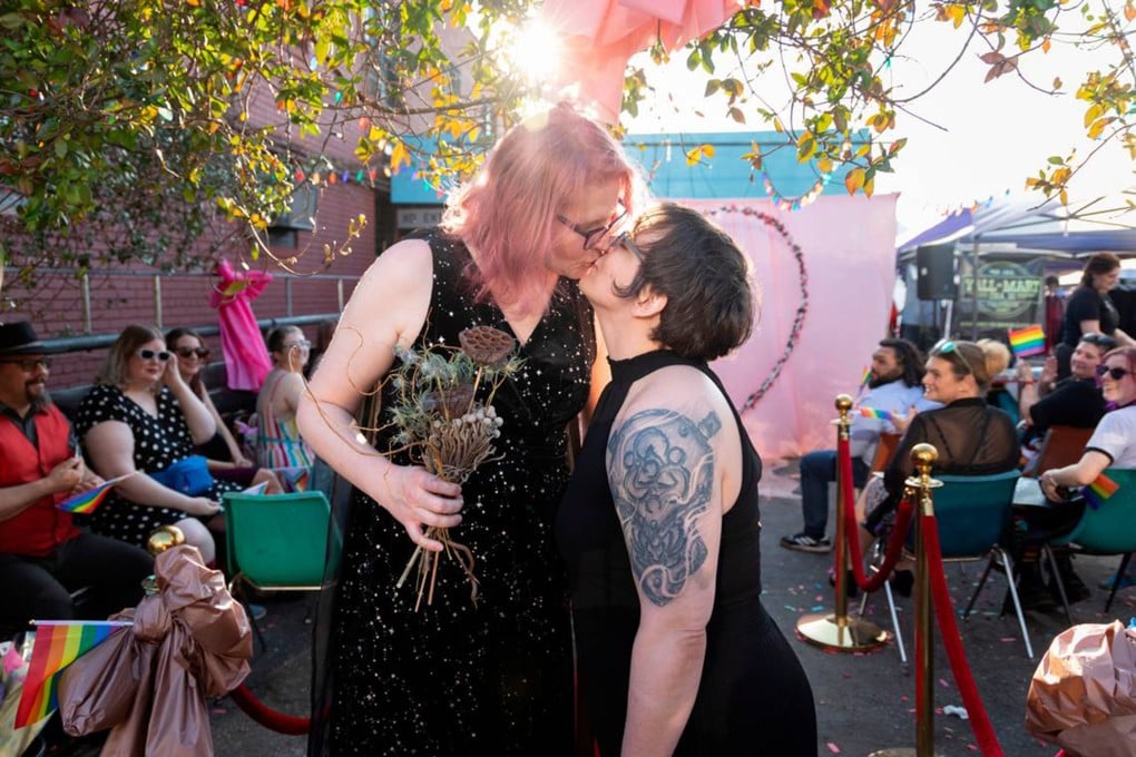 Christine Fowler and her wife Sharon Thrailkill kiss after their wedding at Y’all-Mart, a quarterly art fair series, at Art Bar, in Columbia, South Carolina. Photo: TNS