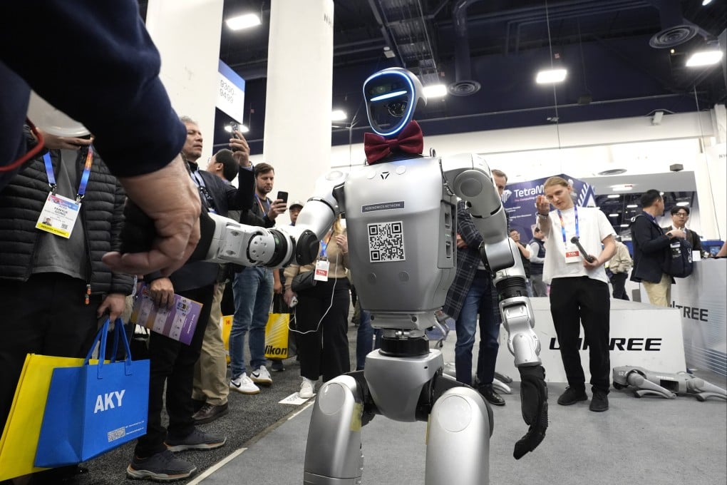 A Unitree H1 robot shakes the hand of an attendee at the Consumer Electronics Show (CES) in Las Vegas in January. Photo: AP