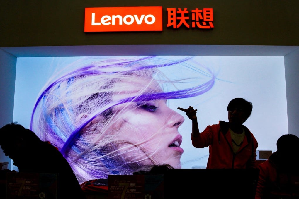 An employee gestures next to a Lenovo logo at Lenovo Tech World in Beijing on November 15, 2019. Photo: Reuters