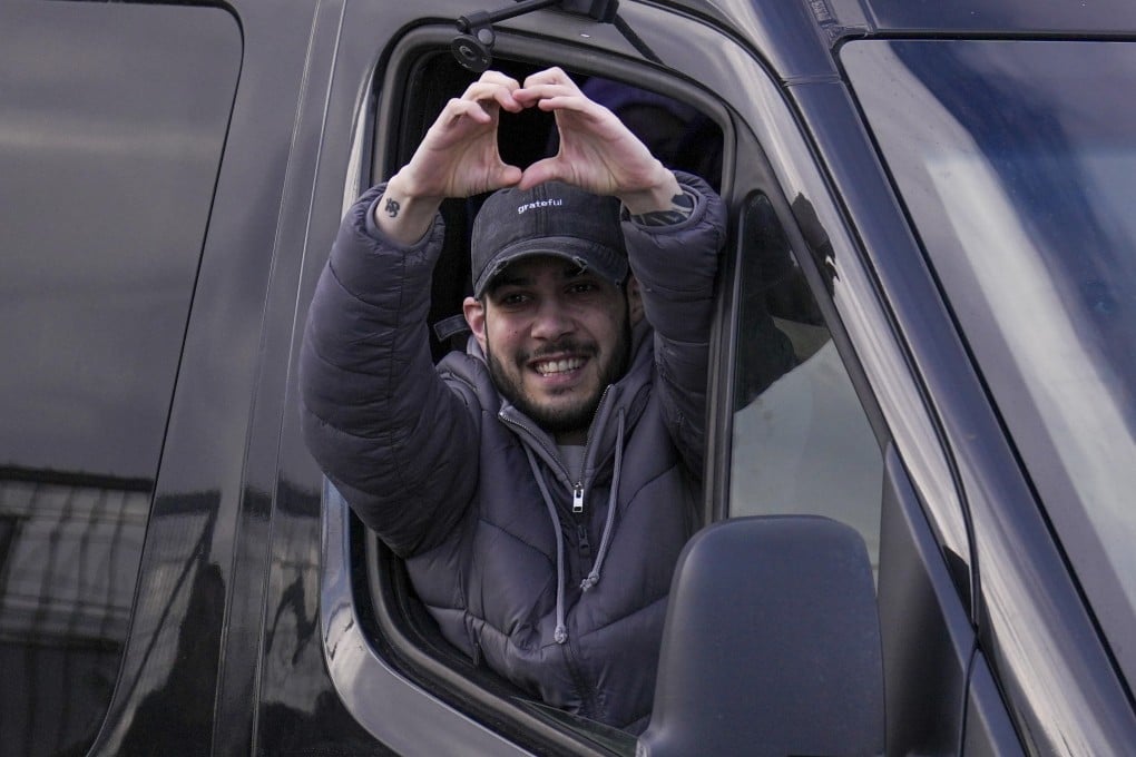 Freed hostage Eliya Cohen gestures from a van as he arrives at Beilinson hospital in Petah Tikva, Israel, on Saturday. Photo: AP