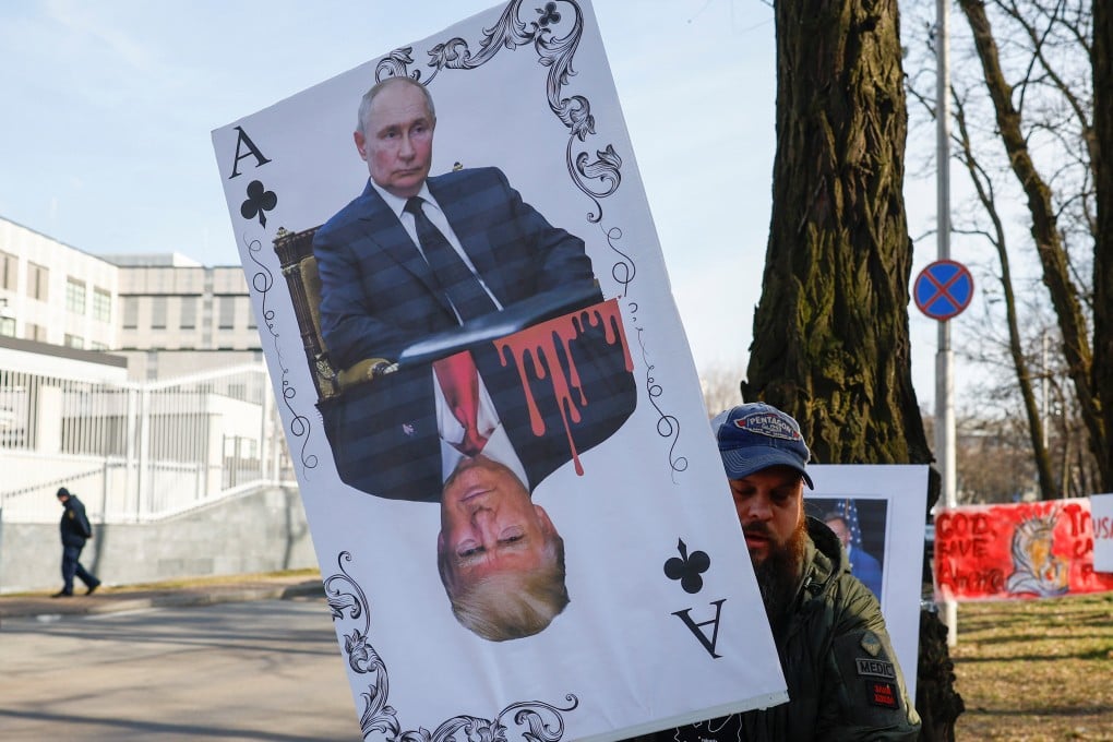 A demonstrator holds a banner depicting a playing card with portraits of Russia’s Vladimir Putin and US President Donald Trump during a rally in Kyiv on March 8. Photo: Reuters