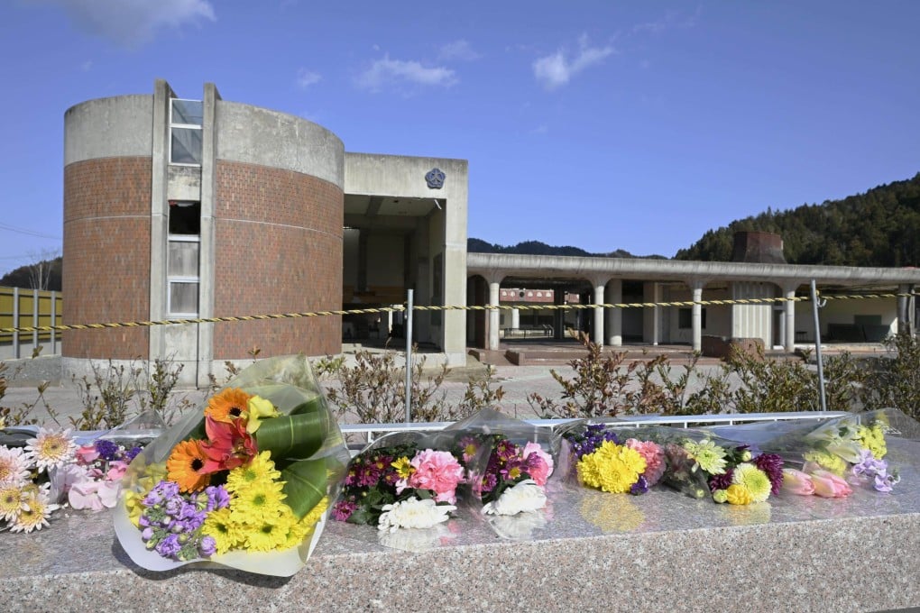 Flowers are seen placed in front of a former school in Ishinomaki, Miyagi prefecture, on Sunday, ahead of the 14th anniversary of the March 11, 2011, earthquake and tsunami that devastated the country’s northeast. Photo: Kyodo