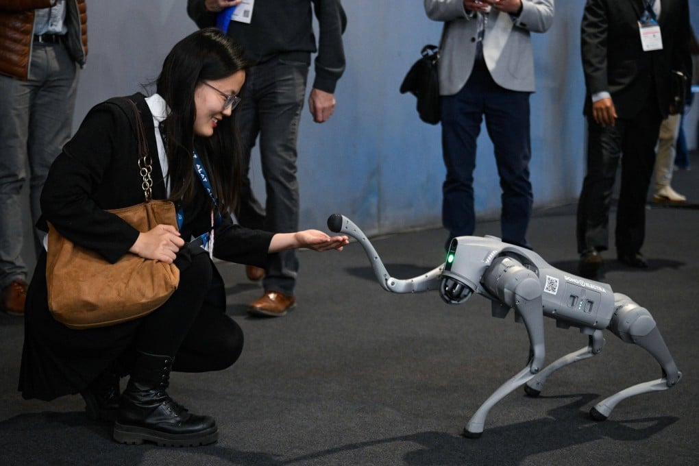A Mobile World Congress attendee interacts with a robot from Unitree Robotics in Barcelona, Spain, on March 3. Photo: AFP
