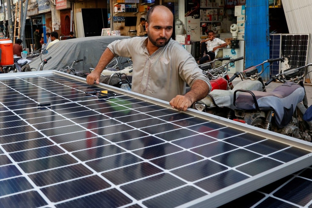 A worker loads solar panels on a vehicle in Karachi, Pakistan. Photo: Reuters