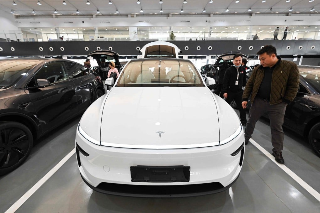 People check out a Tesla electric car at the company’s delivery centre in Beijing on February 27, 2025. Photo: AFP