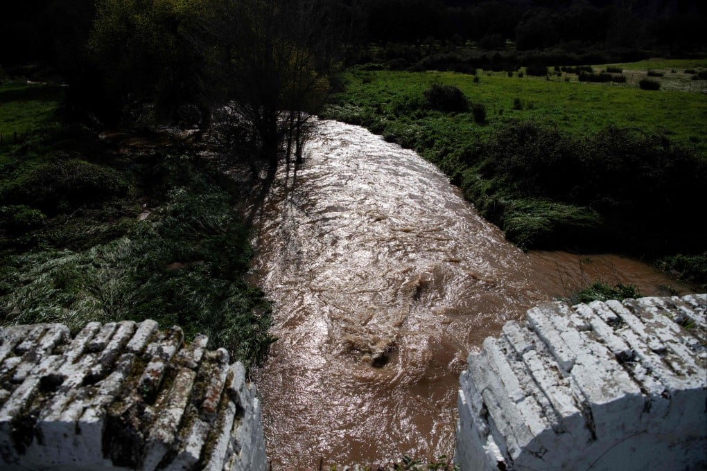 A swollen stream following storms near Constantina, north of Seville, Spain. A woman died and her husband was missing after the stream swept away their car on Tuesday. Photo: AFP