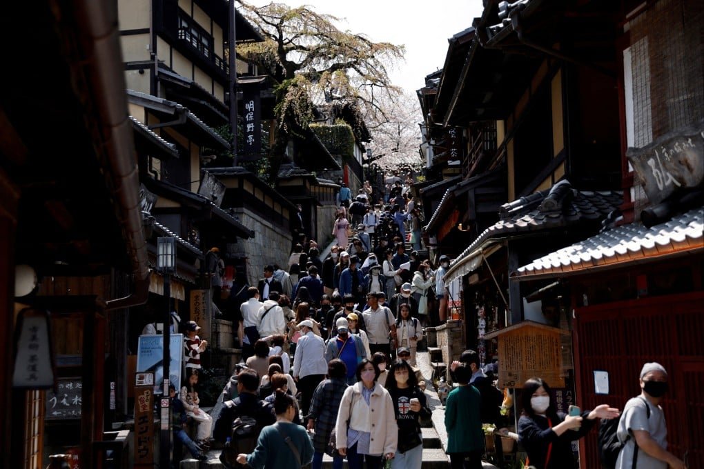 A crowd of tourists walk on a street near the Kiyomizudera temple in Kyoto. Photo: Reuters