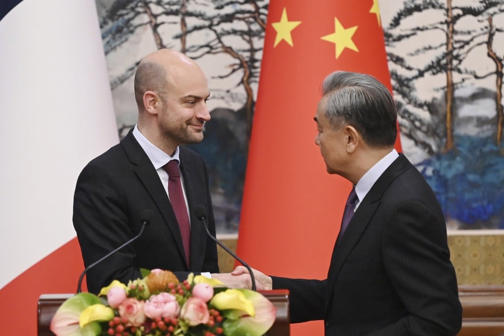 French Foreign Minister Jean-Noel Barrot (left) and Chinese Foreign Minister Wang Yi shake hands hold talks at the Diaoyutai State Guesthouse in Beijing on Thursday. Photo: AP