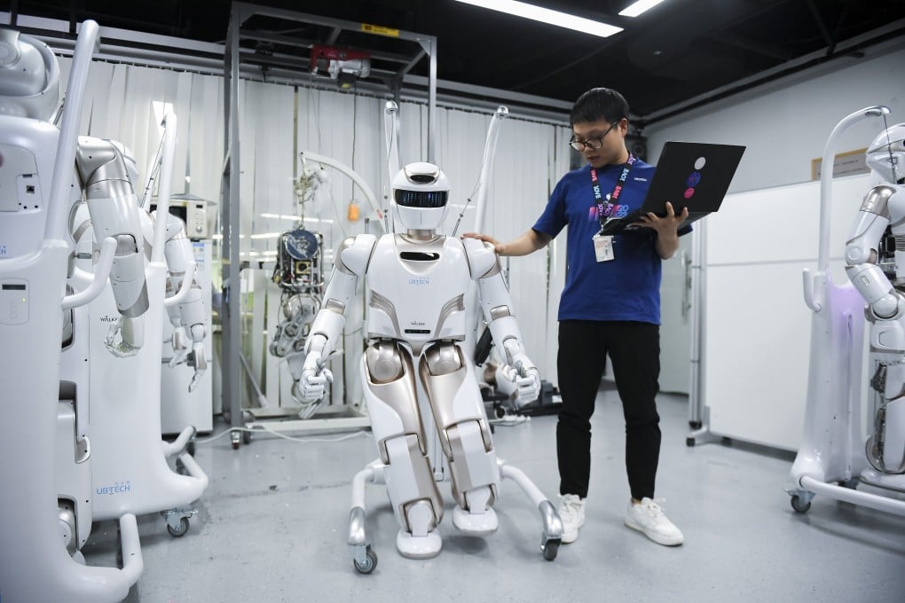 A staff member tests a humanoid robot from a company based in Shenzhen, Guangdong province. Photo: Xinhua