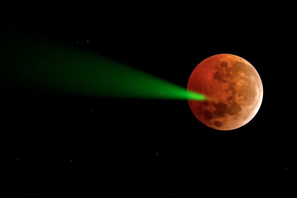 The full moon eclipse targeted with a laser from the Foster Observatory telescope in Santiago, Chile, on March 14. File photo: AFP