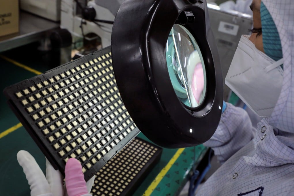 A worker inspects semiconductor chips at the chip packaging firm Unisem (M) Berhad plant in Ipoh, Malaysia. Photo: Reuters