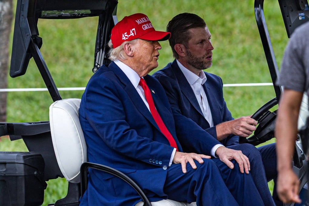 US President Donald Trump and his son Eric Trump drive in a golf cart at Trump National Doral Miami golf course in Doral, Florida on Thursday. Photo: Getty Images / Getty Images via AFP