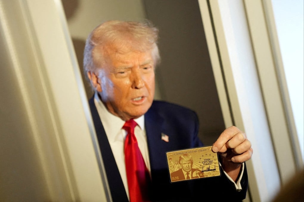 US President Donald Trump holding ‘The Trump Card’. Photo: Reuters