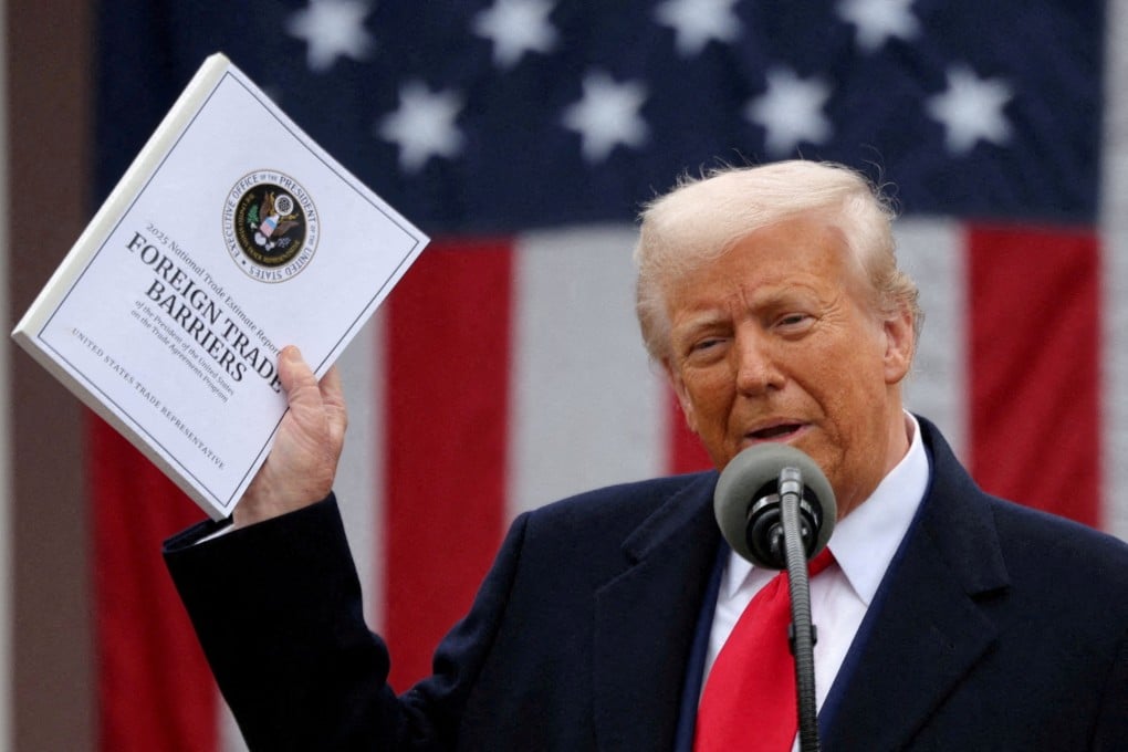 FILE PHOTO: U.S. President Donald Trump holds a “Foreign Trade Barriers” document as he delivers remarks on tariffs in the Rose Garden at the White House in Washington, D.C., U.S., April 2, 2025. REUTERS/Carlos Barria/File Photo/File Photo