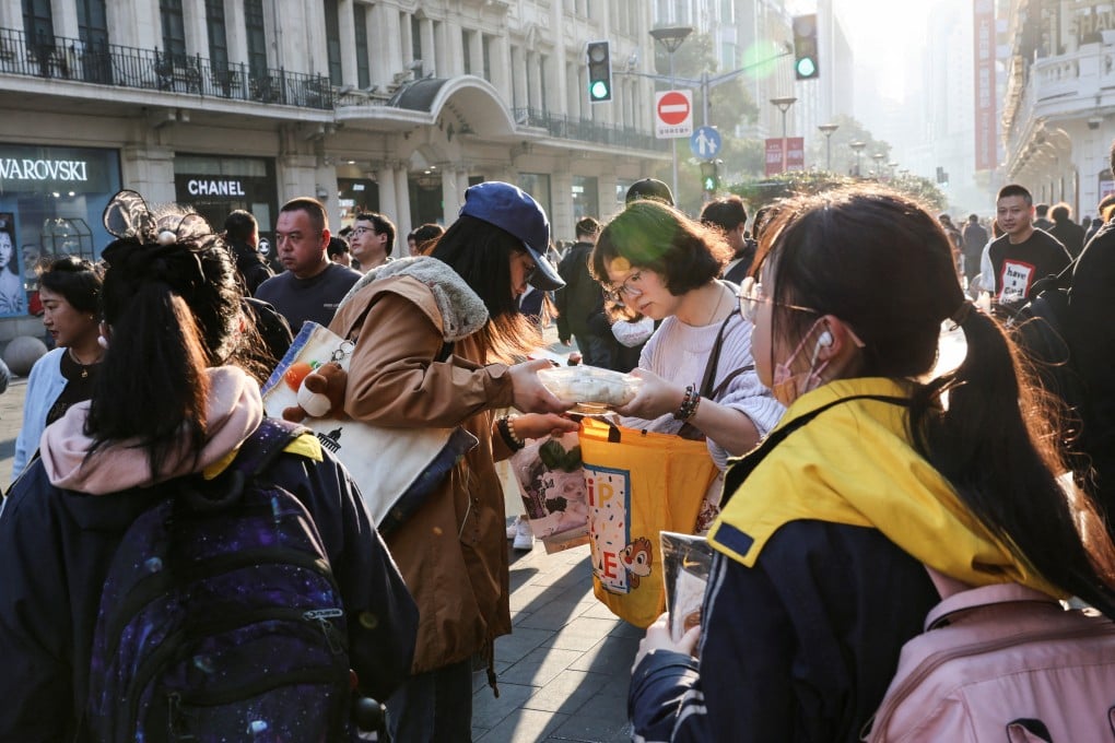 Shoppers in Shanghai on February 28. The property bubble has been lanced, people are braced and households have twice as much savings as debt. There is very little economic downside left for China, and no scenario in which it cannot go on. Photo: Reuters