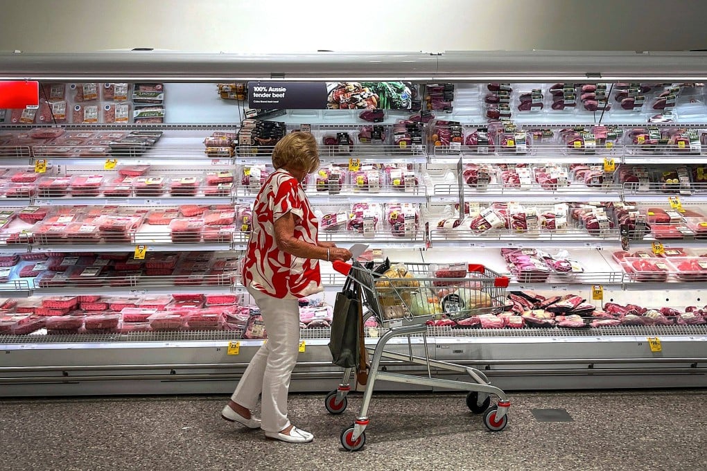 A shopper looks at beef products for sale at a supermarket in Sydney. Australia has been slugged with a 10 per cent tariff on goods exported to the US. Photo: AFP