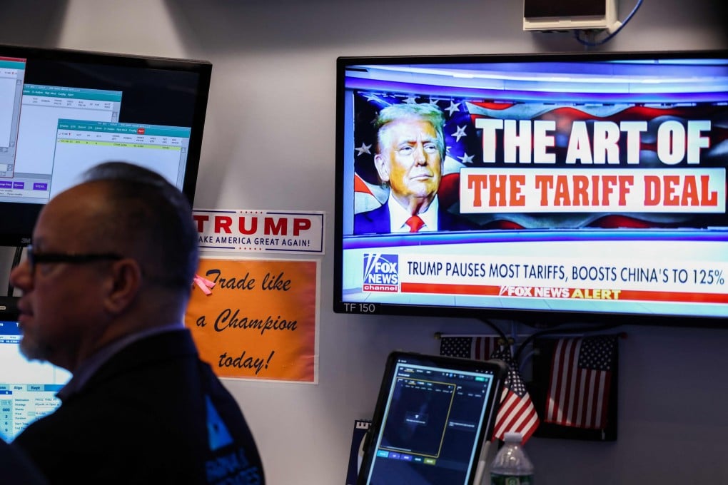 A trader works as a television screen shows news about US President Donald Trump’s trade and tariff policies, on the floor of the New York Stock Exchange on Thursday. Photo: AFP