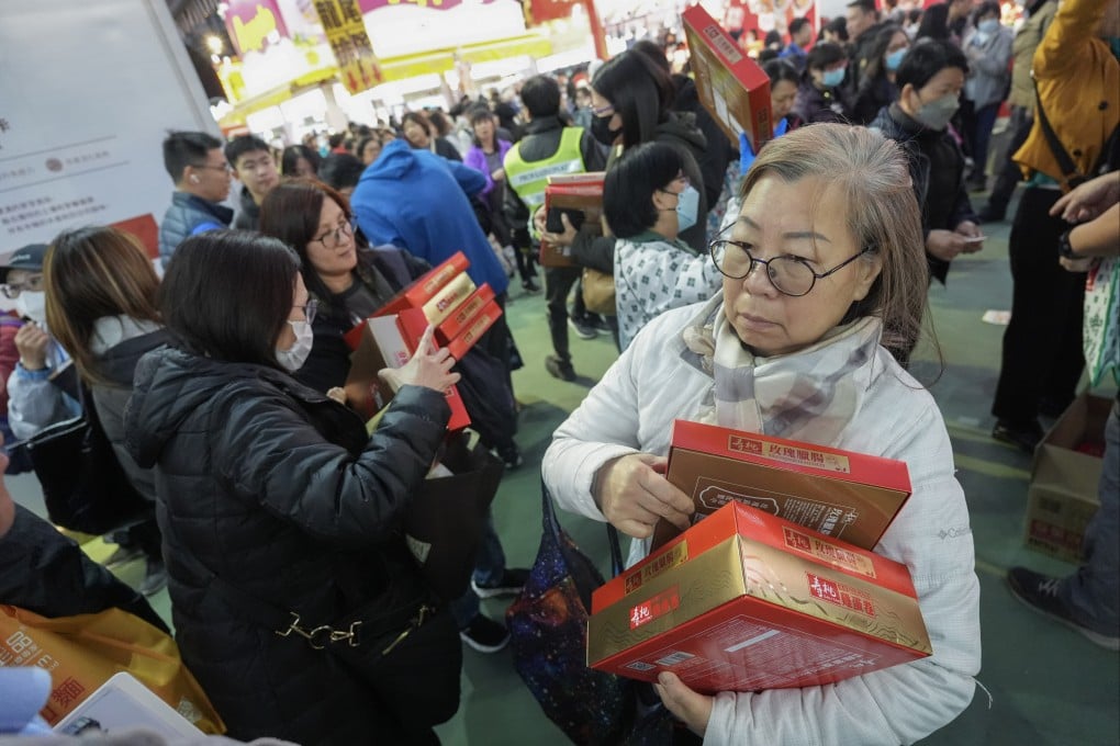 Bargain hunters buy multiple boxes of snacks and preserved foods at the 58th Hong Kong Brands and Products Expo at Victoria Park in Causeway Bay, on December 22, 2024. Photo: Eugene Lee