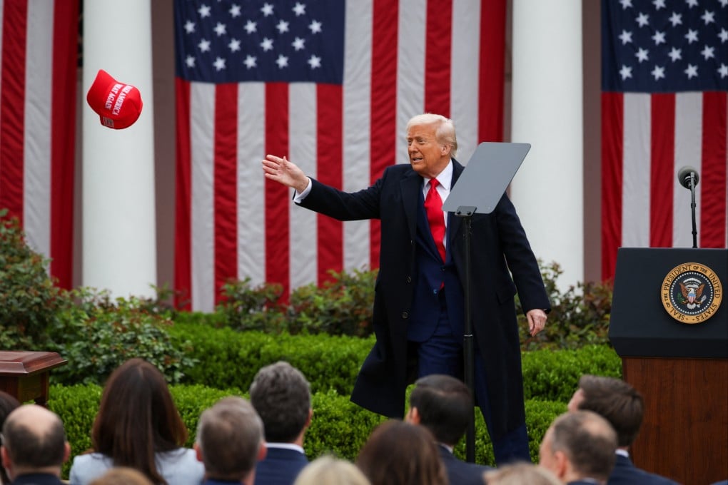 US President Donald Trump tries to reach a Maga hat, on the day of his remarks on tariffs in the Rose Garden at the White House in Washington on April 2. Photo: Reuters