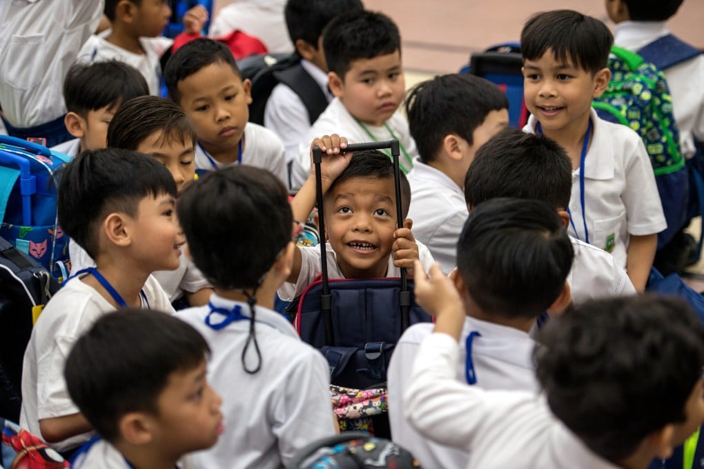 Malaysian students seen with their bags during the first day of schooling for the 2020 session at the Taman Tun Dr Ismail National School. Photo: DPA