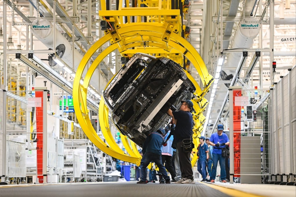 Employees work on the assembly line at Chinese carmaker Seres’ factory in Chongqing. Photo: VCG via Getty Images