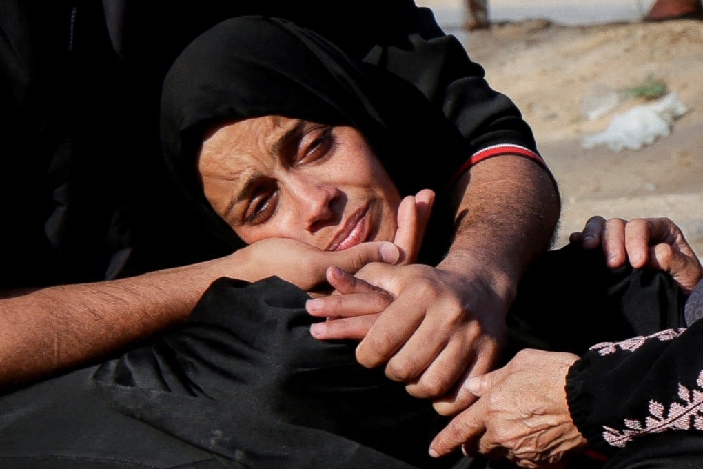 A woman reacts near the bodies of Palestinians killed in Israeli strikes. Photo: Reuters