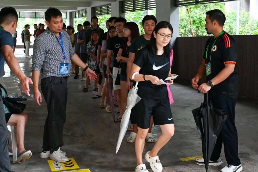 People queue to vote in Singapore’s general election at a polling station in the city state on Saturday. Photo: AFP