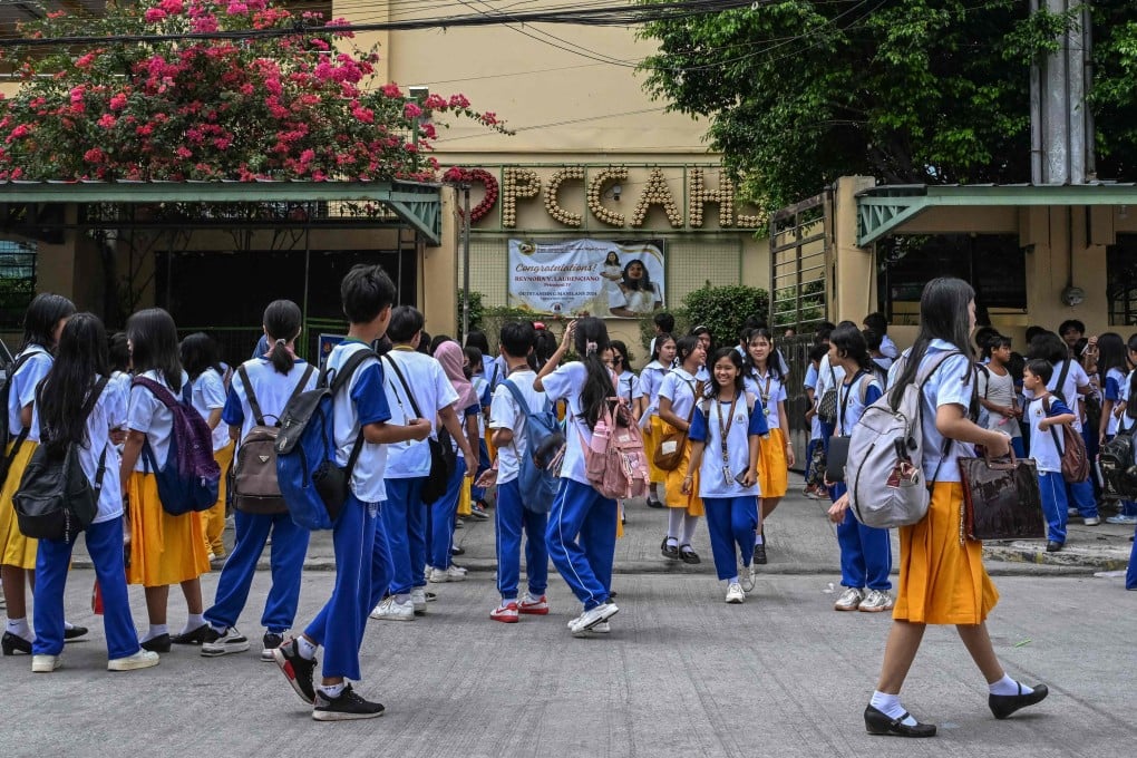 Philippine students waiting for their classes outside a high school in Manila. Photo: AFP