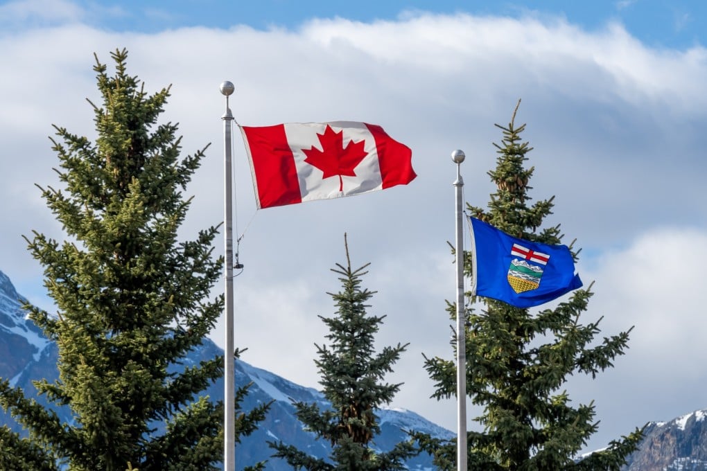 The national flag of Canada and flag of Alberta. Photo: Shutterstock