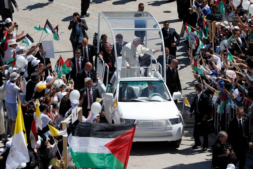 Pope Francis waves to the crowd from his popemobile in Manger Square, Bethlehem, West Bank on May 25, 2014 . Photo: AFP
